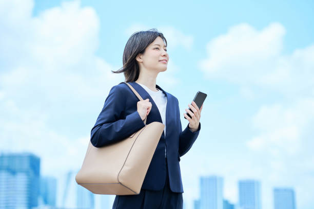 A young woman in a suit commuting to work