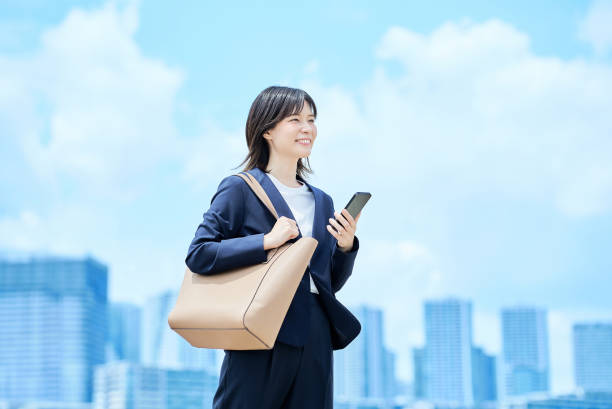 istock A young woman in a suit commuting to work 2157833857