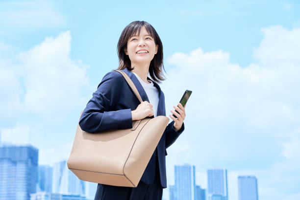 istock A young woman in a suit commuting to work 2157833873