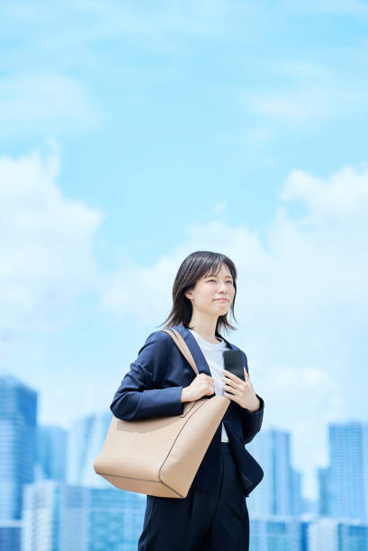 istock A young woman in a suit commuting to work 2157833888