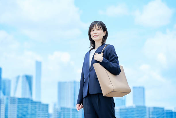istock A young woman in a suit commuting to work 2157833900