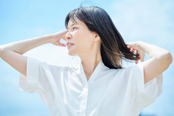 istock Young woman looking up at the sky 2157834757