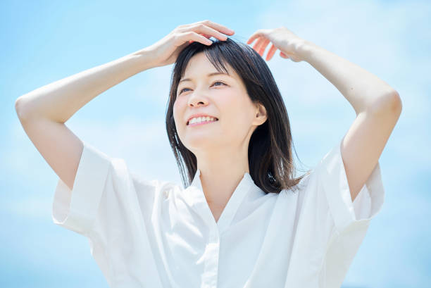 istock Young woman looking up at the sky 2157834797