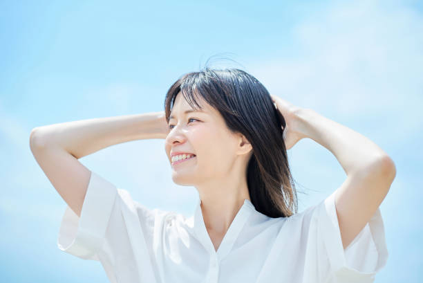 istock Young woman looking up at the sky 2157834803