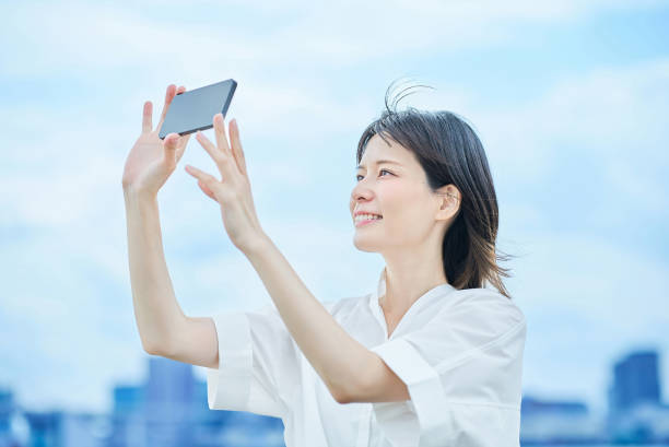 istock Young woman looking at smartphone screen 2157834950