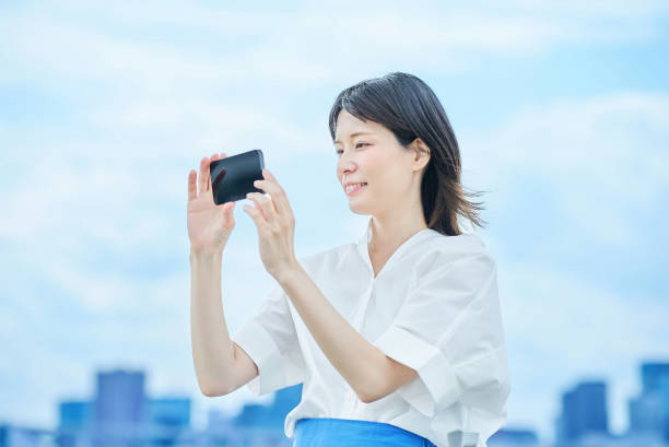 istock Young woman looking at smartphone screen 2157834961