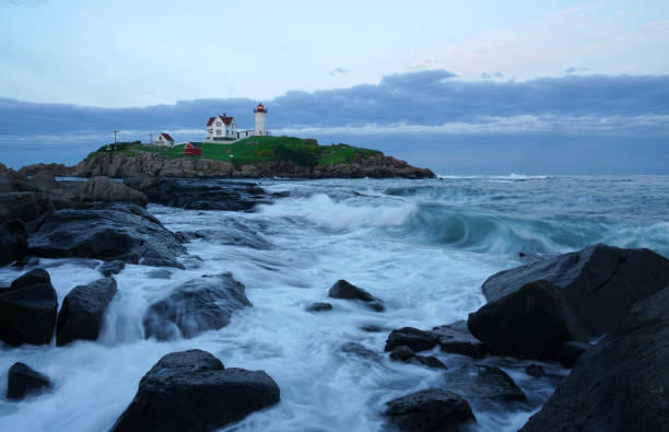 istock nubble lighthouse with rock beach in twilight 2157837366