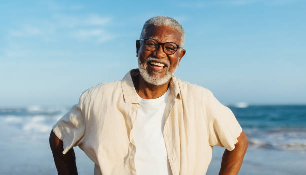 Joyful senior man smiling at the beach