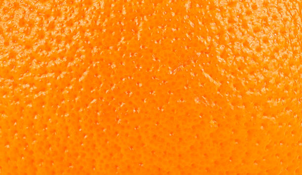 Ripe orange fruit skin as background, citrus fruit.