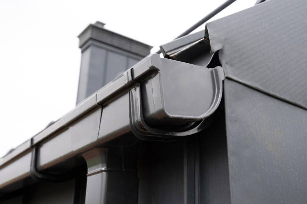 Gutter with downpipe on the roof a house close up