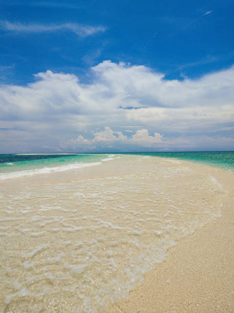 Beautiful ocean waves over the sandbar. Camiguin Island. Philippines.