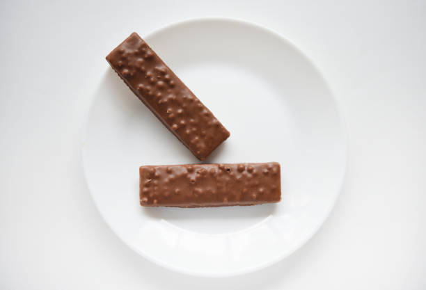 A sweet chocolate bar on a white plate.Waffle chocolate bar on a white background.