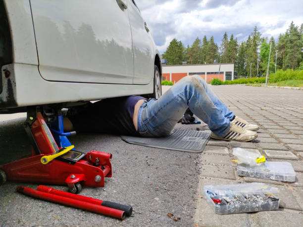 istock A man is repairing a car, lying under the car. 2157845446