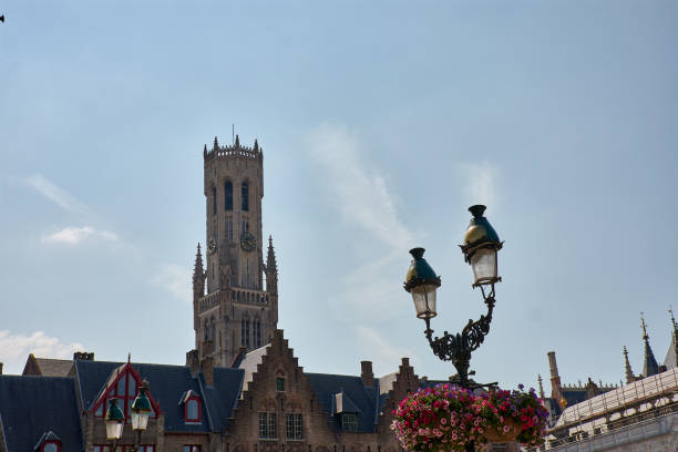 Bruges, Belgium; June,06,2024; The bell tower of a Bruges church, or Belfort, is a medieval alarm tower in the historic center of Bruges, Belgium. One of the most prominent symbols of the city.