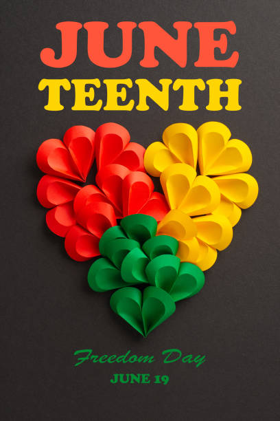 istock A creative vertical representation of Juneteenth using colorful paper hearts in red, yellow, and green arranged in the shape of a larger heart on a dark background 2157846298