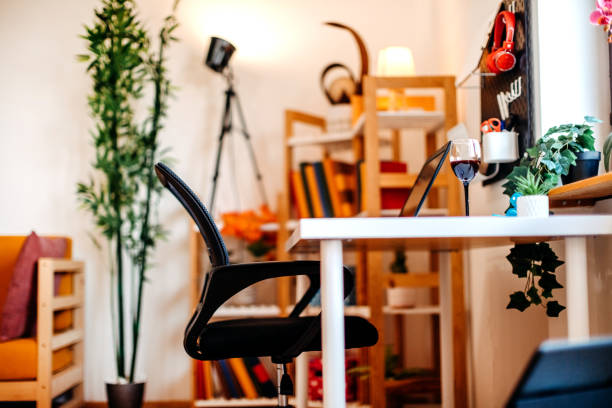 istock Wine glass on working desk next to laptop 2157849727