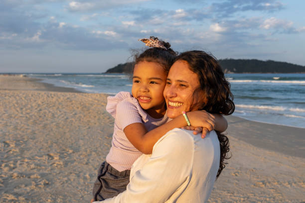 istock Daughter hugs her mother on the beach 2157850535
