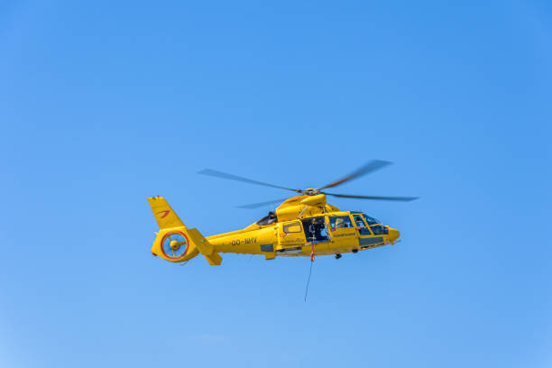 Rotterdam, Netherlands - September 3 2022: Coastguard rescue helicopter against a clear blue sky. model AS365N3 Dauphin 2