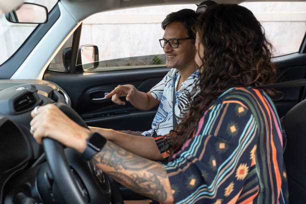 istock Latin man using tablet on woman driving car 2157851840
