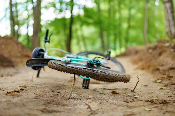 istock Track bicycle abandoned on a muddy forest path, a juxtaposition of human activity and nature 2157852167
