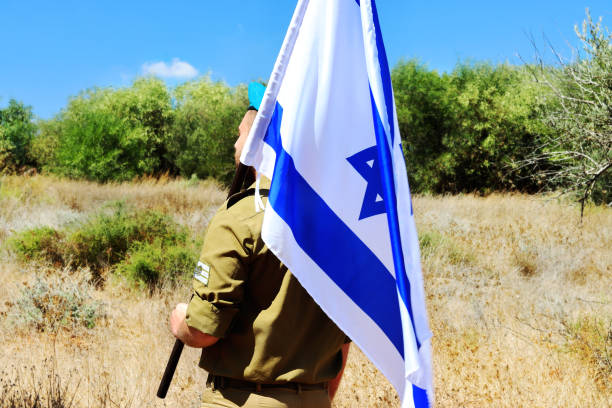 istock Israeli soldier with Israel flag 2157852205