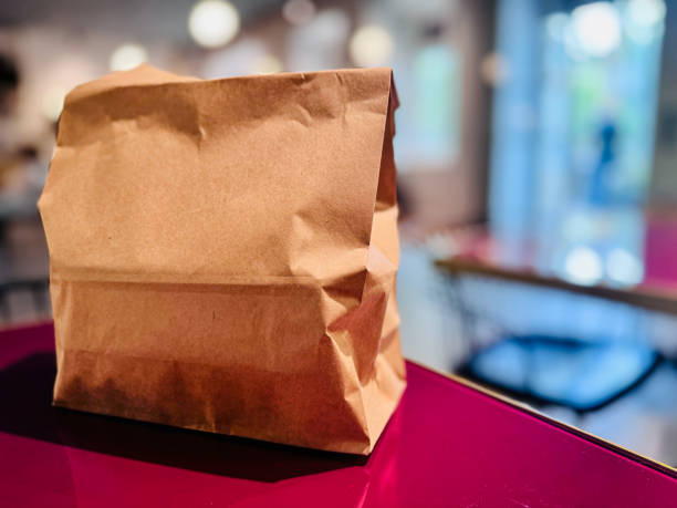 istock Brown Paper Bags on Red Table 2157855142