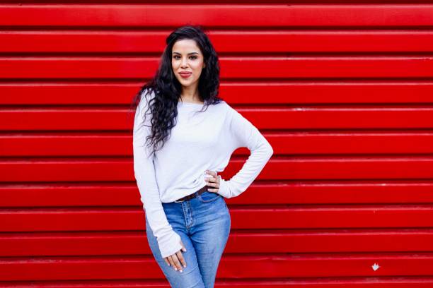 istock Beautiful female posing for the picture on a red background 2157856502