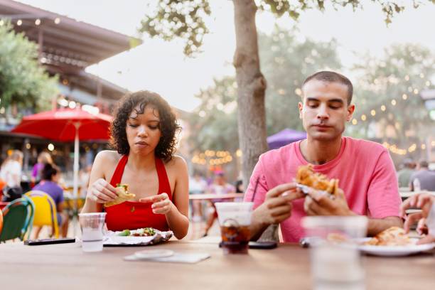 istock Multiracial friends eating outdoors 2157857131