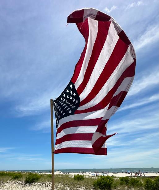 istock American Flag Flying On The Beach 2157858181