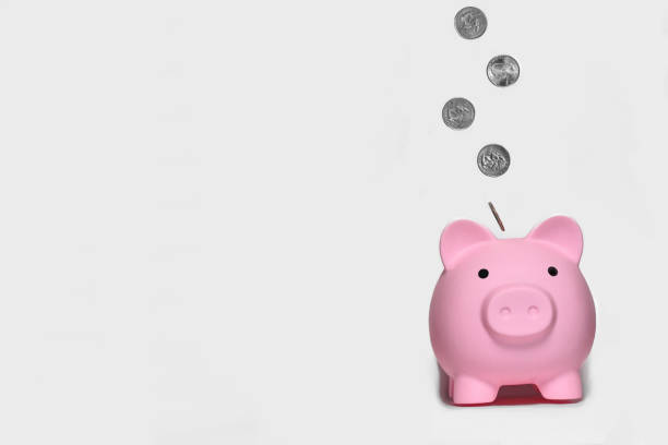 Money. Coins. Savings. USA coins flying into piggy bank