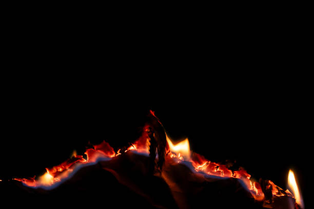 istock burning paper, glowing edge of paper on a black background 2157859596