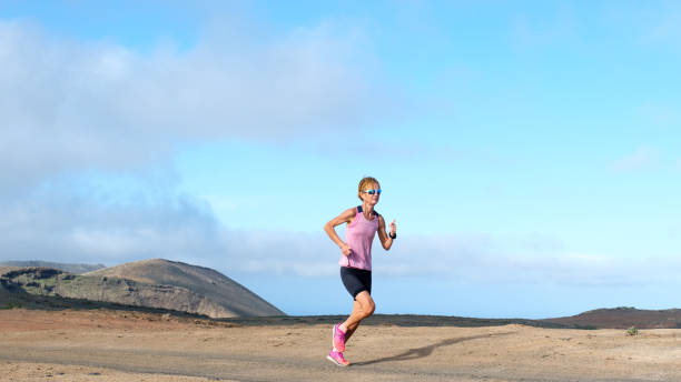 istock Vibrant female runner in stark surroundings 2157861001