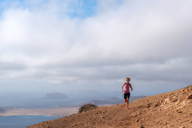 istock Woman running on trail with scenic ocean view 2157861767