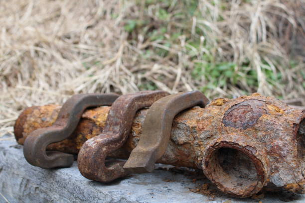 istock Rusted Metal Gate Part Lying On A Stone Wall 2157862014