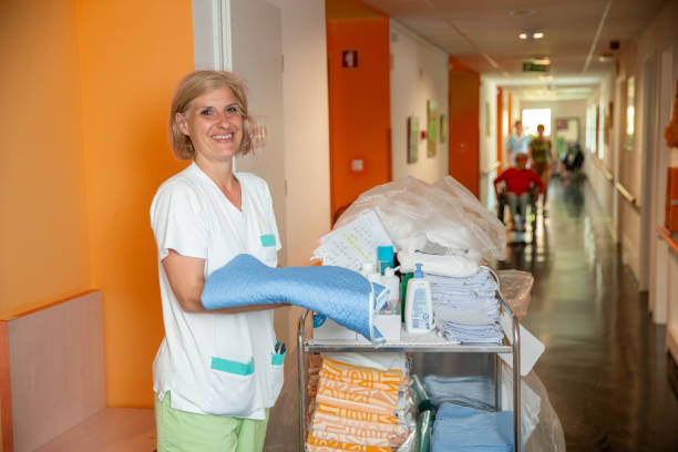 Nurse delivering clean sheets and towels in a Nursing home