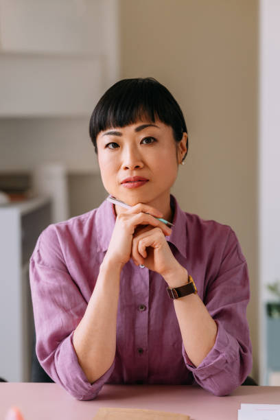istock Thoughtful Woman Sitting at Desk in Office 2157872707