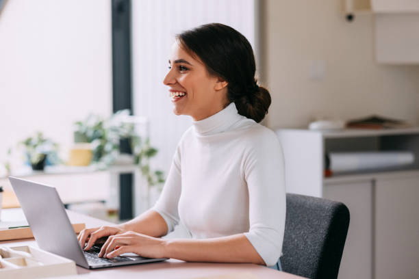 istock Smiling Woman Working on Laptop in Modern Office 2157872716