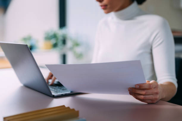 istock Woman Working on Laptop While Reviewing Documents in Office 2157872804