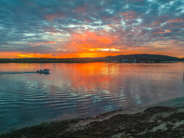 istock Sunrise over the bay water with clouds and reflections 2157875223
