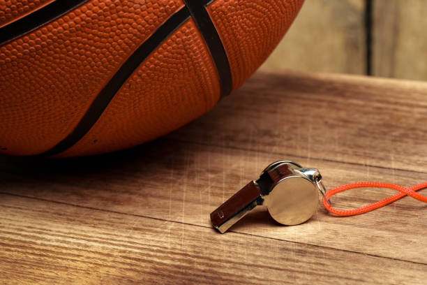 Basketball ball lying on a wooden floor close up