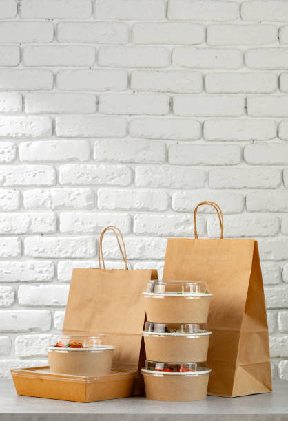 istock Take out food in boxes and craft bag against brick background 2157877784