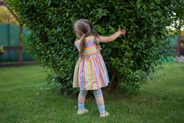 a toddler in a pink cloud of a dress runs like an airplane png, isolated,