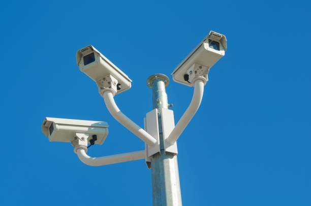 istock Three CCTV cameras against a clear blue sky 2157888434