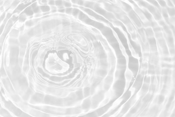 istock White water with ripples on the surface. Defocus blurred transparent white colored clear calm water surface texture with splashes and bubbles. Water waves with shining pattern texture background. 2157889281