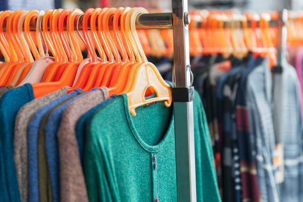 istock Sweaters and other clothing on hangers and racks. 2157892189
