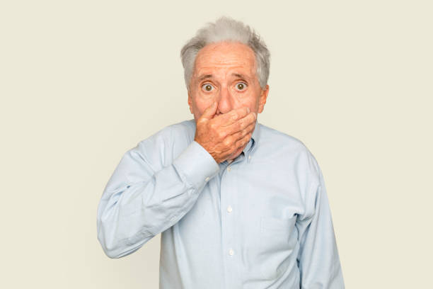 istock Shocked senior man with hand covering his mouth 2157892843