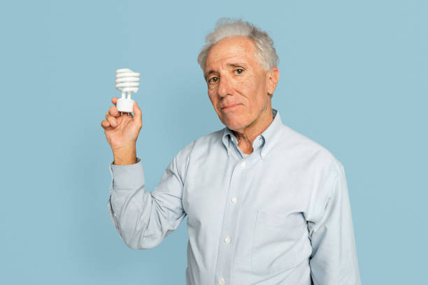istock Senior businessman holding a light bulb for innovation campaign 2157892854