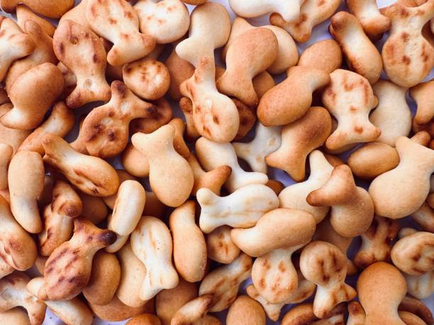 istock Heap of fish shape salty crackers.  Snack food full frame texture background. 2157897716