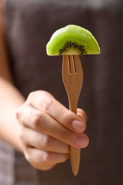Sliced green kiwi fruit on fork ready to eating, Healthy fruit