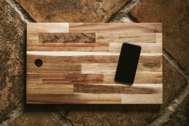 istock Mobile phone mockup on wooden cutting board flatlay 2157898555